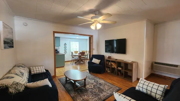 a living room with furniture and a flat screen tv