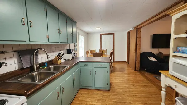 a kitchen with sink a refrigerator and cabinets