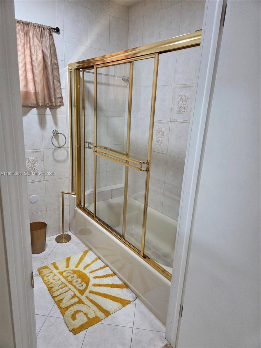 2931 Southwest 135th Avenue Miami, FL 33175 - Photo 19 of 20 a bathroom with a glass shower door and a sink