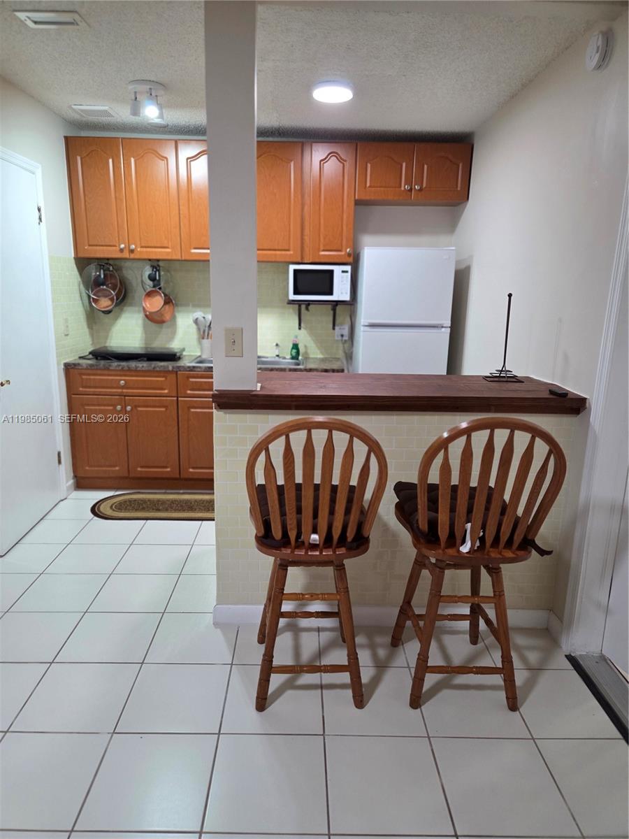 2931 Southwest 135th Avenue Miami, FL 33175 - Photo 7 of 20 a view of a kitchen with stainless steel appliances granite countertop a sink and a refrigerator