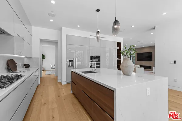 a kitchen with sink a stove and cabinets