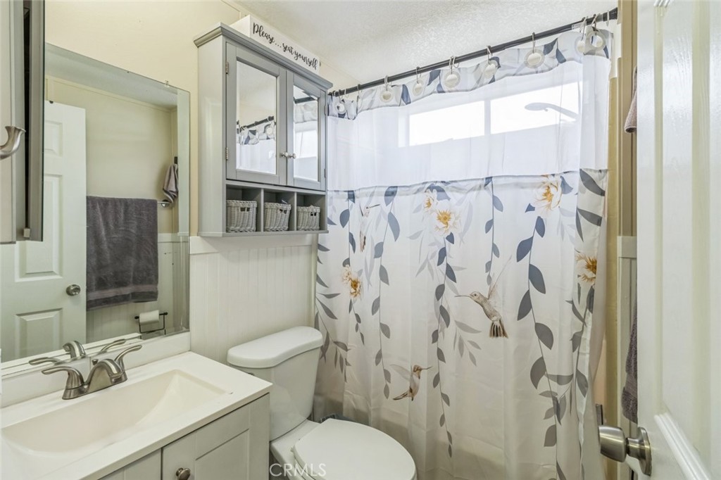 8221 Ilex Street, Unit 10 Rancho Cucamonga, CA 91739 - Photo 11 of 12 a bathroom with a sink and a mirror