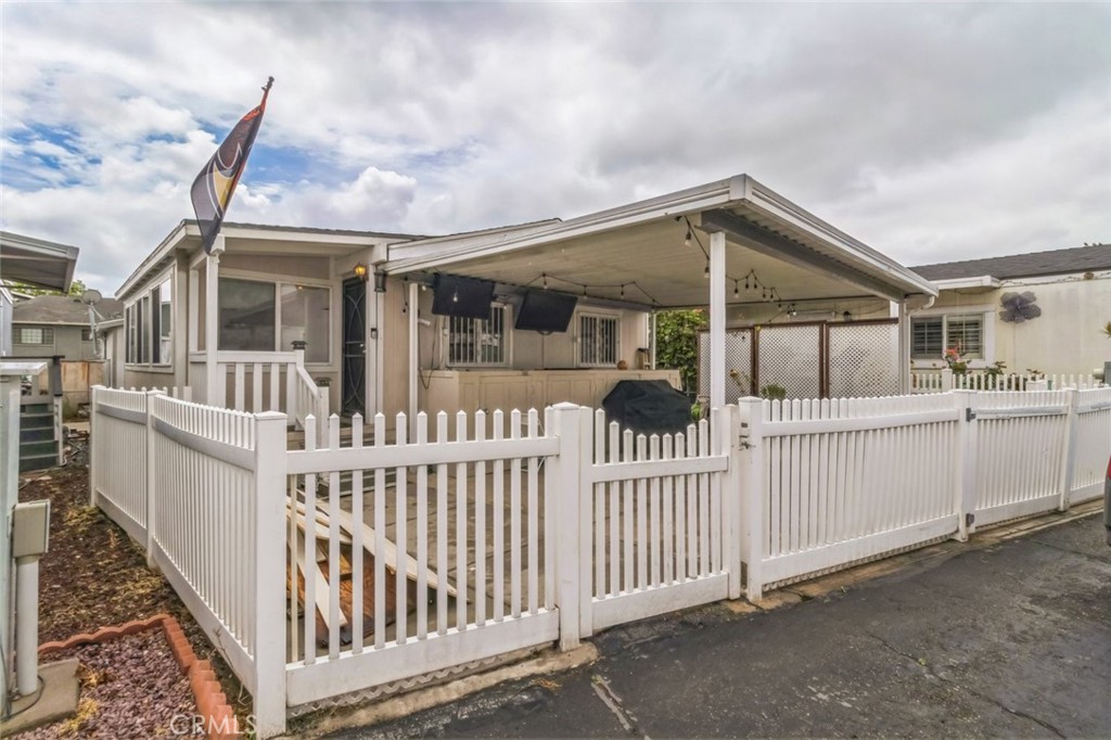 8221 Ilex Street, Unit 10 Rancho Cucamonga, CA 91739 - Photo 2 of 12 a view of a house with wooden fence