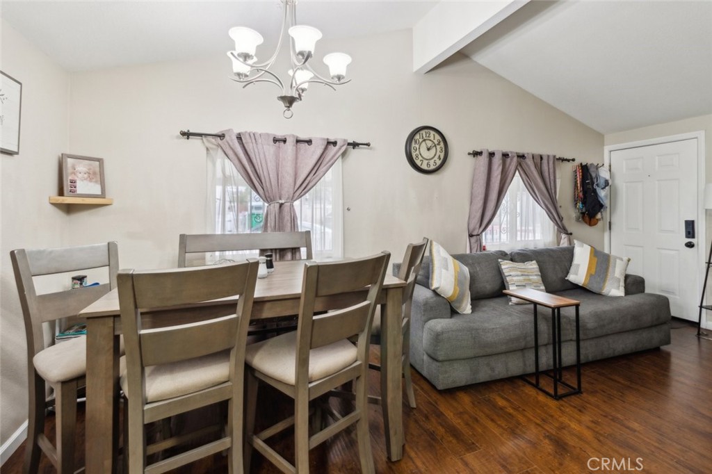 8221 Ilex Street, Unit 10 Rancho Cucamonga, CA 91739 - Photo 6 of 12 a living room with furniture a dining table and a chandelier