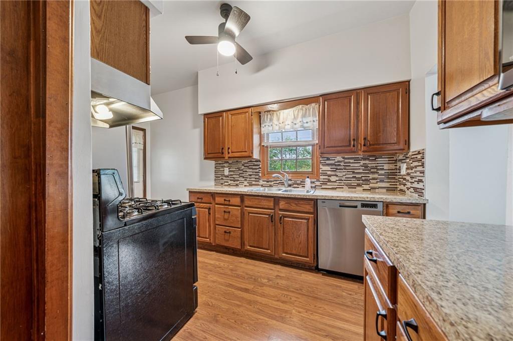 15 Hickory Street Burgettstown, PA 15021 - Photo 15 of 36 a kitchen with granite countertop cabinets a sink a window and stainless steel appliances