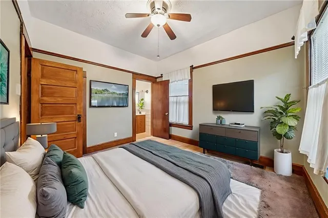 an empty room with windows and fan