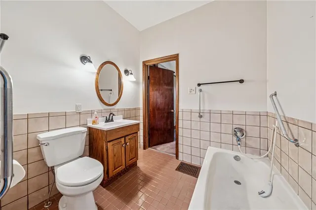 an empty room with closet and windows