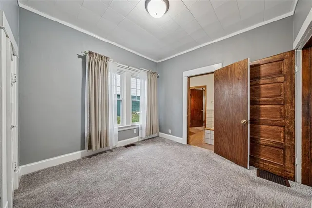 a view of an empty room and closet area