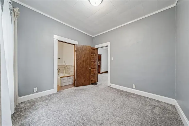 a view of staircase with railing and white walls