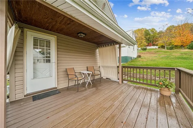a view of a house with a yard and sitting area