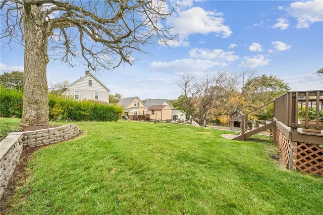 an aerial view of lake residential house with swimming pool and green space