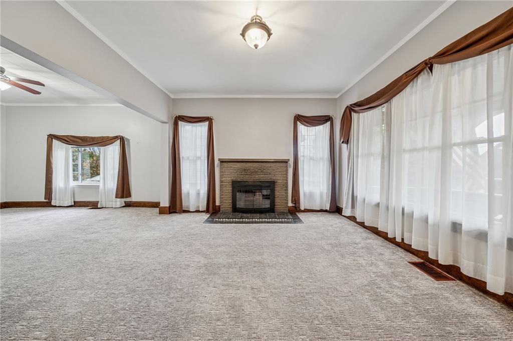 15 Hickory Street Burgettstown, PA 15021 - Photo 6 of 36 an empty room with windows and a fireplace