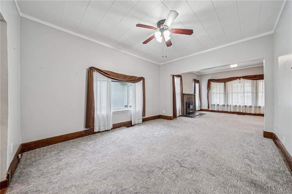 15 Hickory Street Burgettstown, PA 15021 - Photo 9 of 36 an empty room with chandelier fan and windows