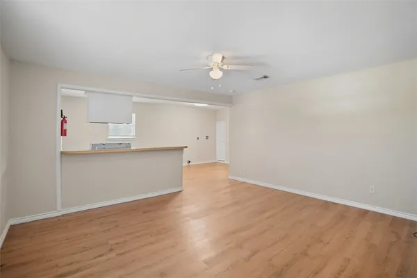 a view of kitchen with wooden floor and window