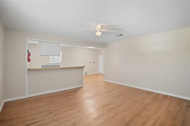 a view of kitchen with wooden floor and window
