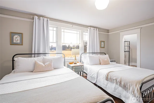 a living room with furniture a flat screen tv and windows