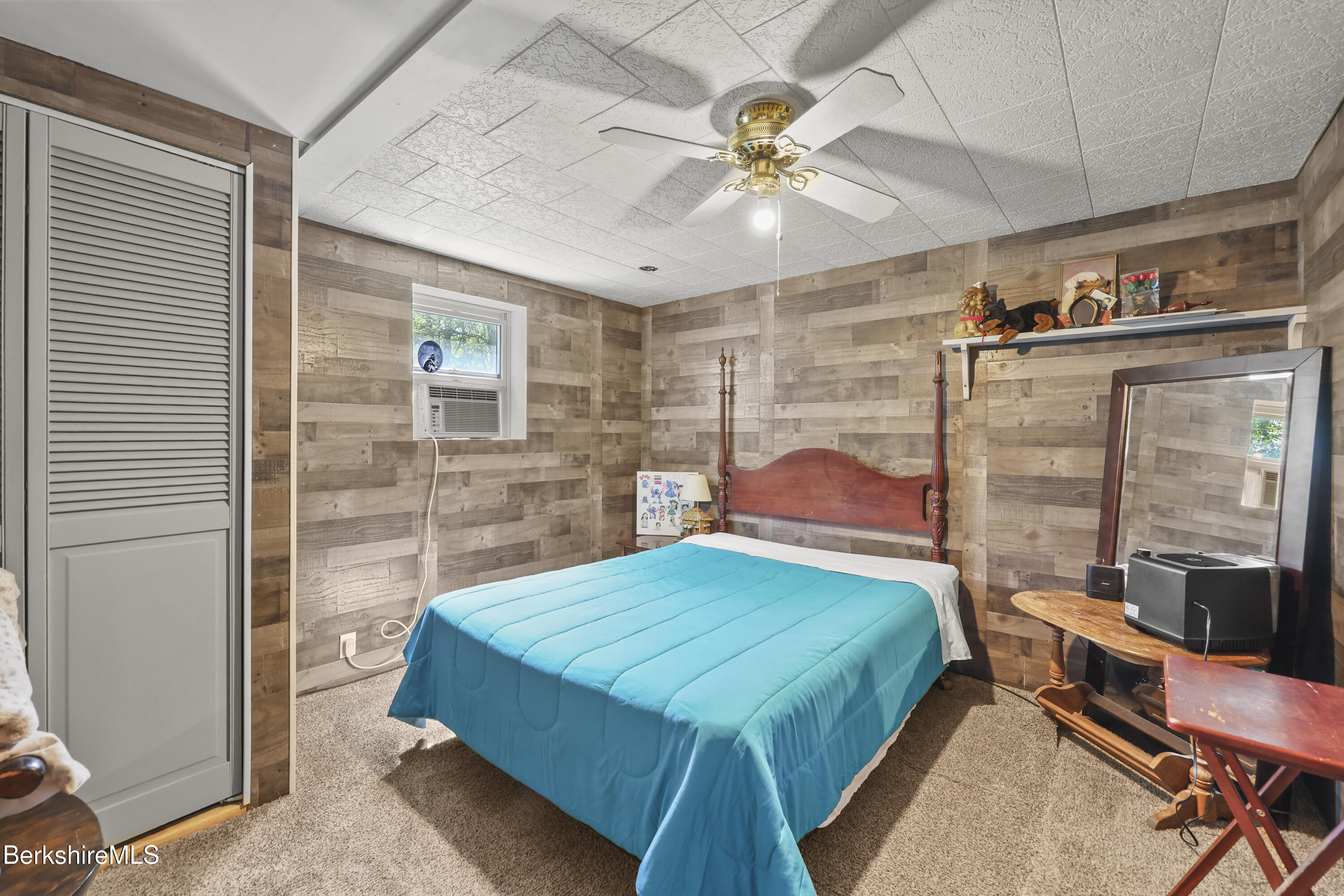 192 Curran Road Cheshire, MA 01225 - Photo 23 of 50 a bedroom with a large bed and a chandelier