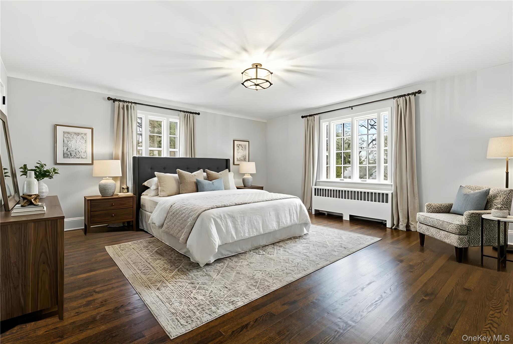 37 Bates Road Harrison, NY 10528 - Photo 20 of 41 a spacious bedroom with a bed a table and chair