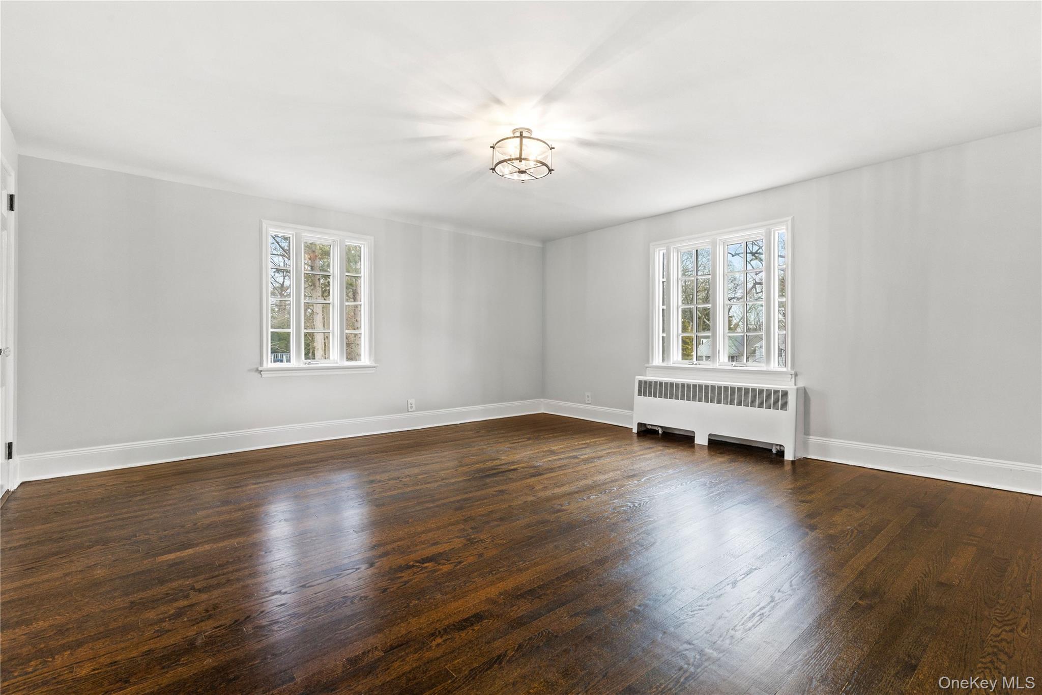 37 Bates Road Harrison, NY 10528 - Photo 21 of 41 a view of an empty room with wooden floor and a window