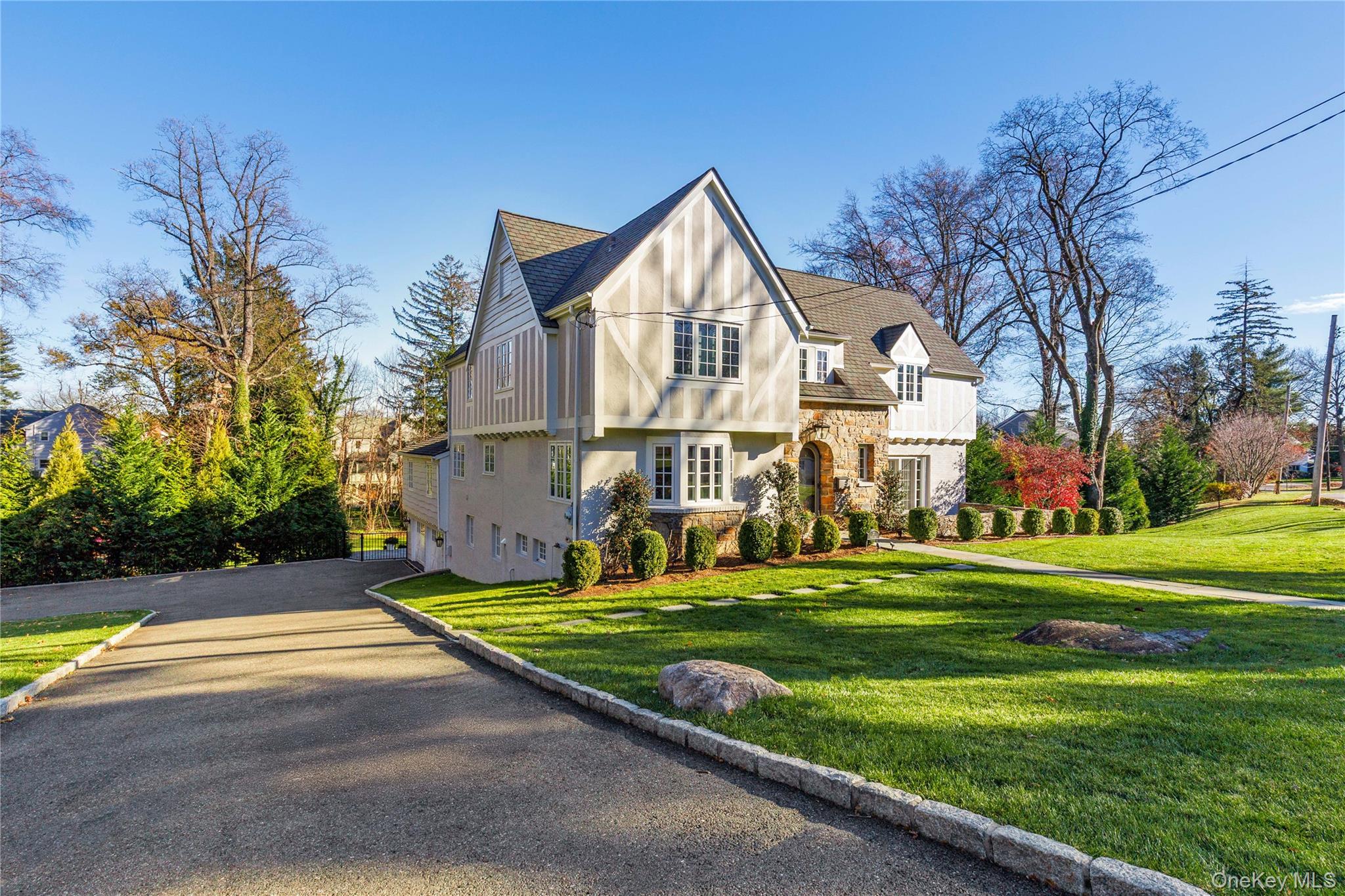 37 Bates Road Harrison, NY 10528 - Photo 33 of 41 a view of a house with a big yard and large trees