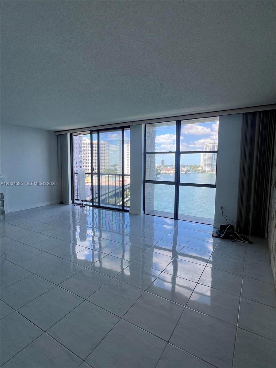 17500 North Bay Road, Unit S907 Sunny Isles Beach, FL 33160 - Photo 13 of 24 wooden floor in an empty room with a window