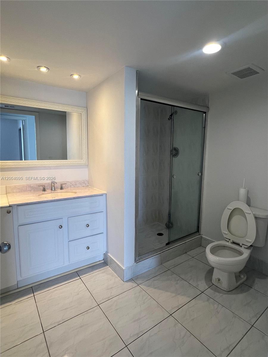 17500 North Bay Road, Unit S907 Sunny Isles Beach, FL 33160 - Photo 14 of 24 a bathroom with a granite countertop sink toilet and shower