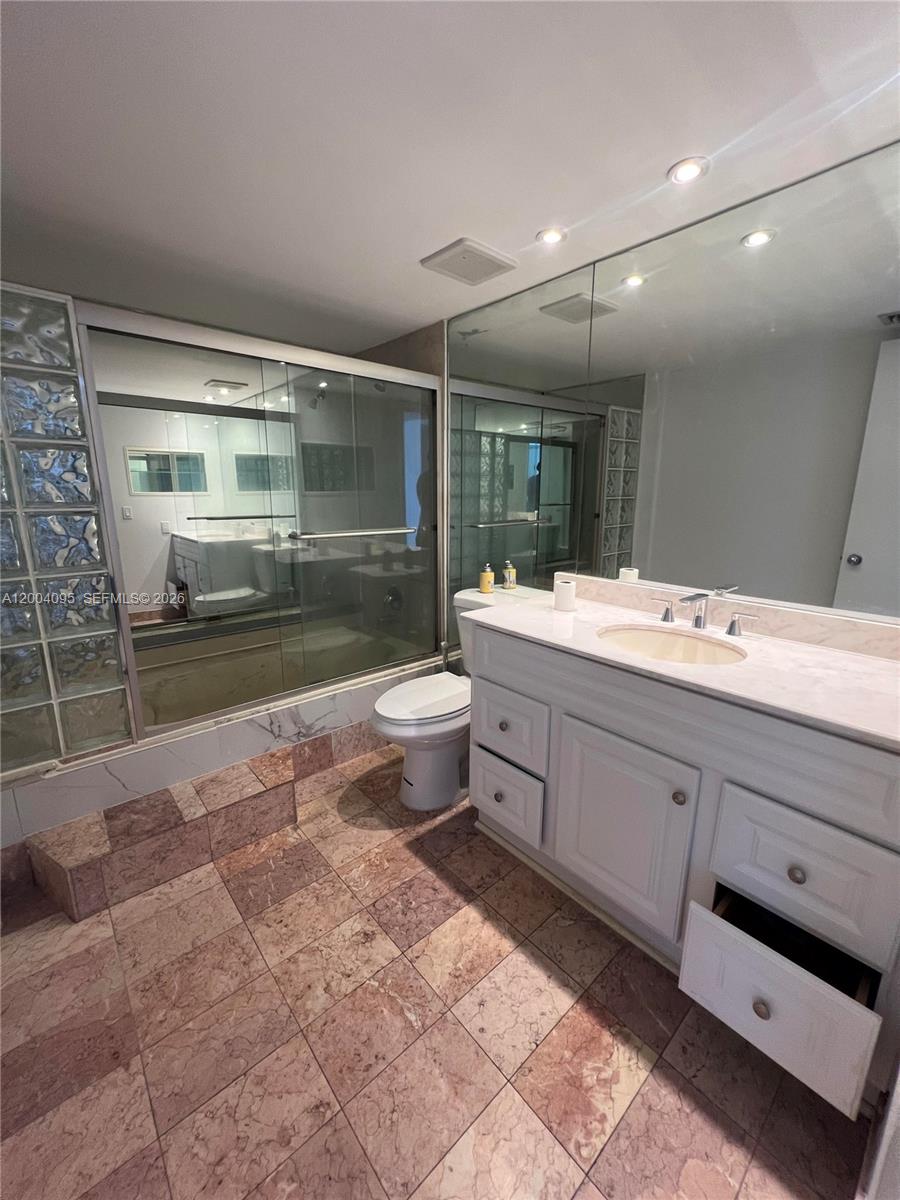 17500 North Bay Road, Unit S907 Sunny Isles Beach, FL 33160 - Photo 21 of 24 a bathroom with a sink a toilet and shower