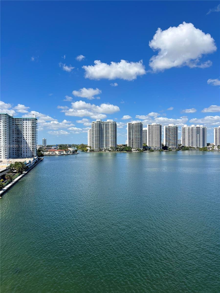 17500 North Bay Road, Unit S907 Sunny Isles Beach, FL 33160 - Photo 24 of 24 a view of a lake with lawn chairs