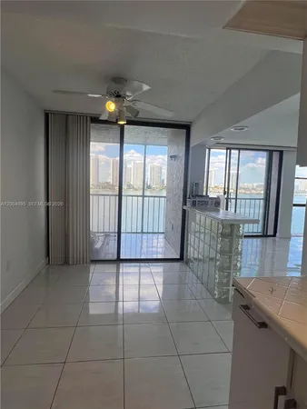 an empty room with windows and chandelier