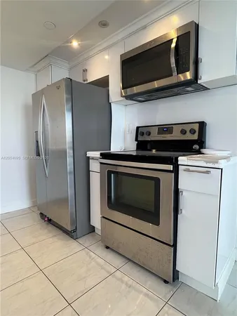 a kitchen with cabinets and steel stainless steel appliances