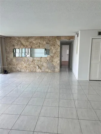 a view of an empty room with a fireplace