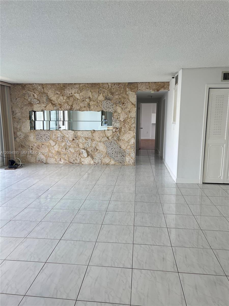 17500 North Bay Road, Unit S907 Sunny Isles Beach, FL 33160 - Photo 9 of 24 a view of an empty room with a fireplace