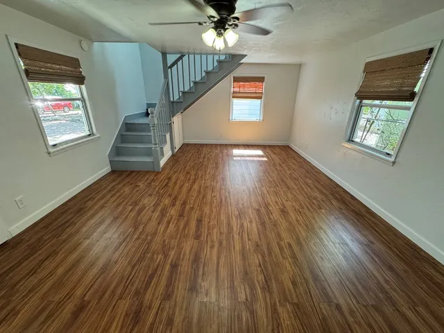 wooden floor in an empty room with a window