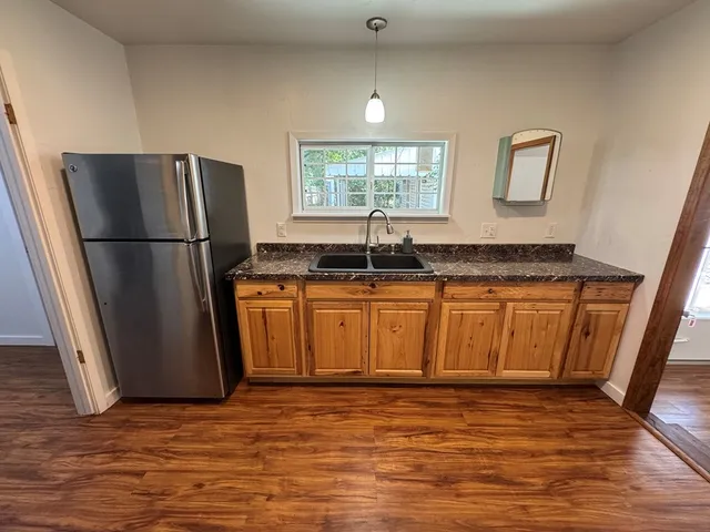 a kitchen with stainless steel appliances granite countertop a refrigerator a sink a stove a microwave and island