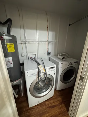 a utility room with dryer washer and a view of kitchen