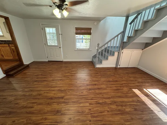 a view of entryway and hall with wooden floor