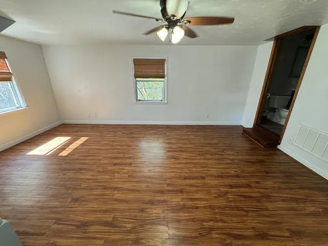a view of room with window and ceiling fan