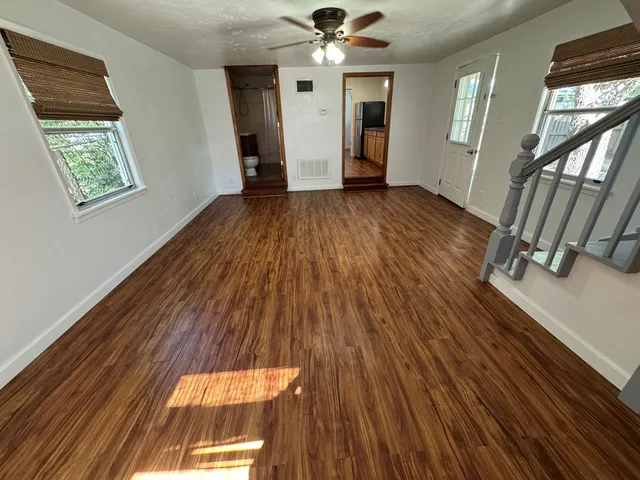 wooden floor in an empty room with a window