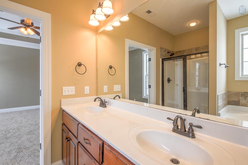 1208 Rimrock Road Smyrna, TN 37167 - Photo 17 of 20 a bathroom with a double vanity sink a mirror and shower