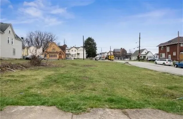 a backyard of a house with table and chairs
