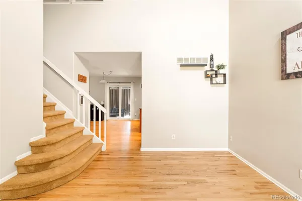 a view of entryway and hall with wooden floor