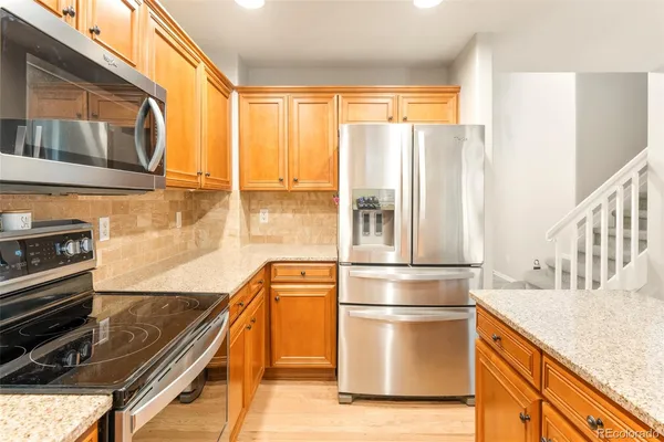 a kitchen with kitchen island a counter top space a sink and stainless steel appliances