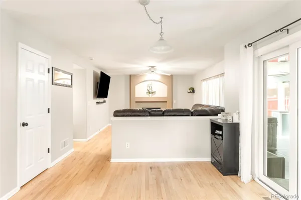 a kitchen with stainless steel appliances granite countertop a refrigerator a sink dishwasher a stove and white countertops with wooden floor