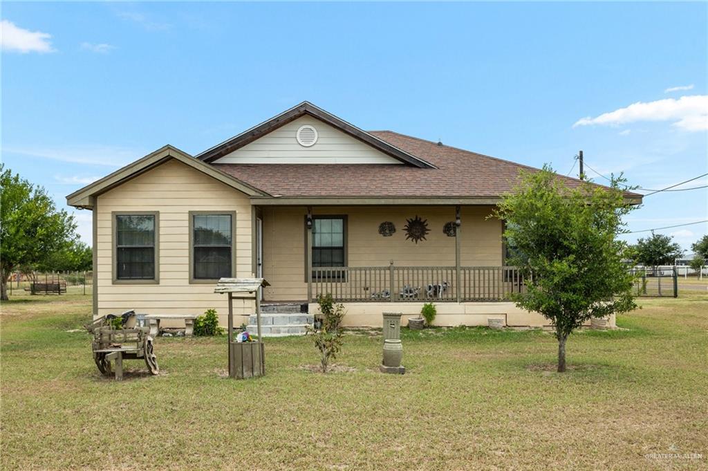 22504 North Val Verde Road Edcouch, TX 78538 - Photo 1 of 1 View of front of home with a porch, a shingled roof, and a front yard