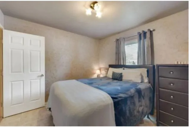 a bedroom with a large bed and a dresser