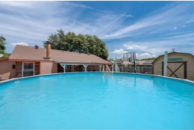 a view of a house with a backyard