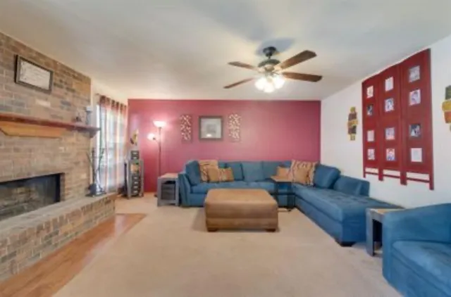 a living room with furniture and a fireplace