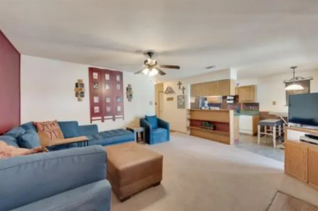 a living room with furniture and kitchen view