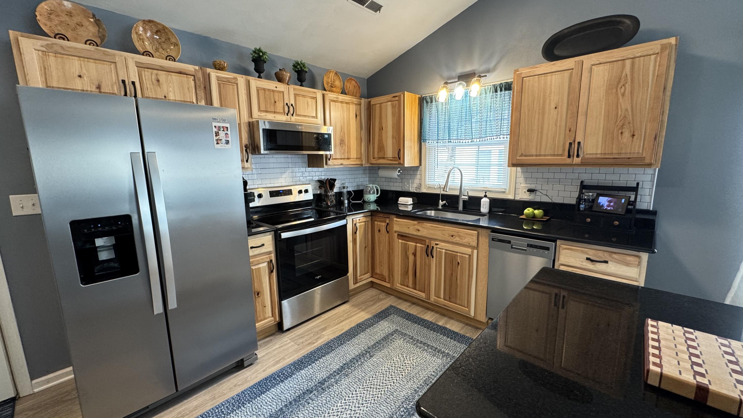 2917 Elderwood Road Salem, VA 24153 - Photo 3 of 24 a kitchen with stainless steel appliances a refrigerator sink and cabinets