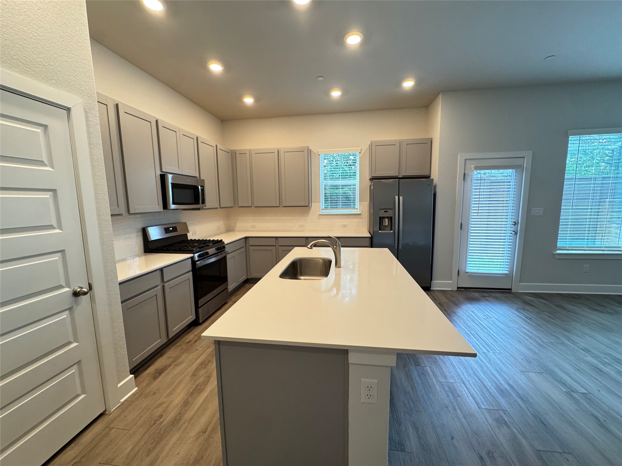 3000 Chisholm Trail Road, Unit 20 Round Rock, TX 78681 - Photo 4 of 26 A well-appointed kitchen showcasing contemporary cabinetry, bright counters, and durable wood-look flooring.